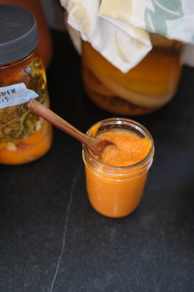 Smooth blended carrot cayenne hot sauce with a vibrant orange color