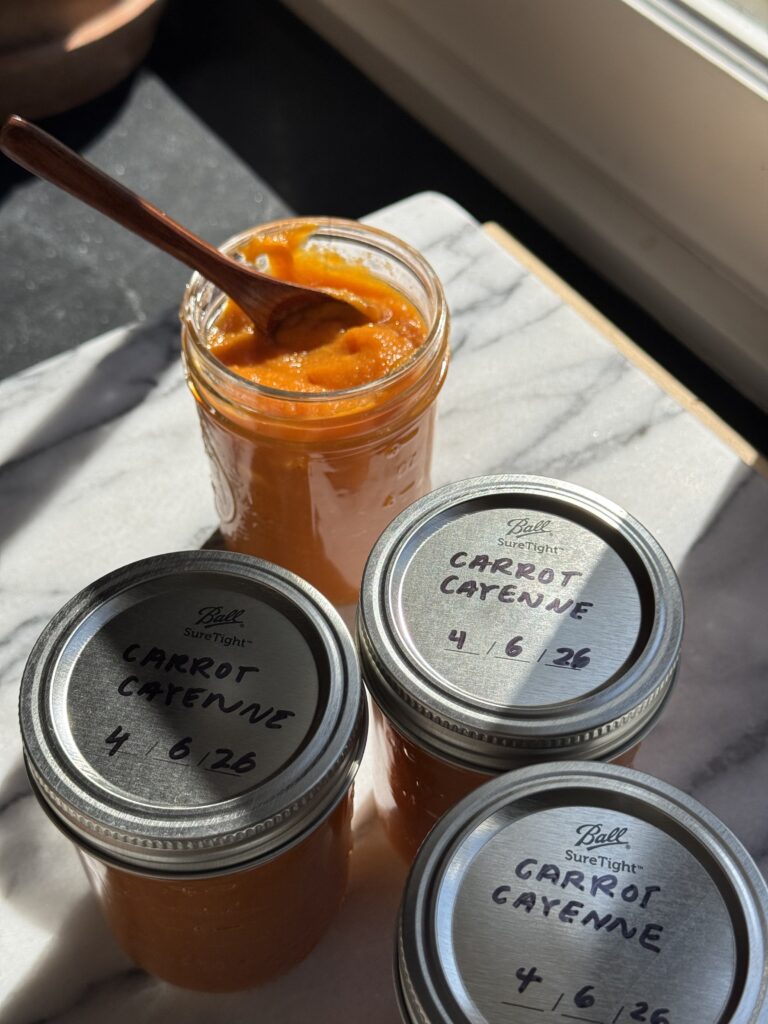 Finished carrot cayenne hot sauce in half-pint jars